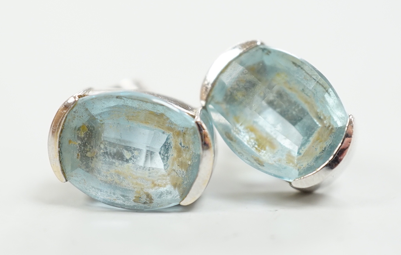 A modern pair of 750 white metal and single stone blue topaz set ear studs, length 13mm, gross weight 5.6 grams.
